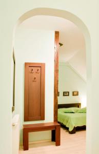 a bedroom with a bed and a wooden table at Casa Vacanza Brasov in Braşov