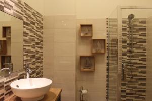 a bathroom with a sink and a shower at Szarotka II in Szczecin