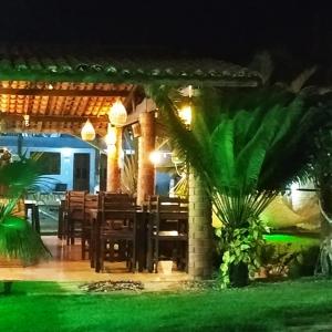 a dining area of a resort at night at Vila Pura Vida in Canoa Quebrada