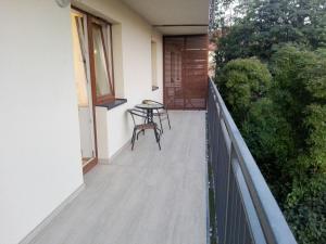 a balcony of a house with a table and chairs at Apartamet Marzenie 7 - Opole in Opole