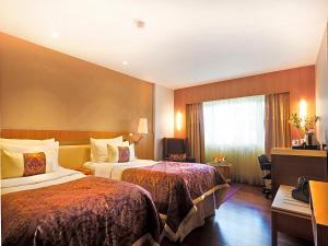 Postel nebo postele na pokoji v ubytování Hotel Bawa International