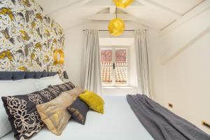 a bedroom with a bed and a window at Old Town House with Floor Heating & Lush Private Garden in Dubrovnik
