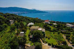 an aerial view of a house on a hill next to the ocean at L'antica Pigna Chateau in Vico Equense