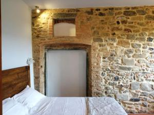 a bedroom with a brick wall and a white door at Casa Pancole in Cavriglia +35 photos