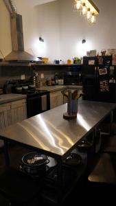 a kitchen with a table in the middle of it at HOSTEL Auberge Clarksdale in Clarksdale