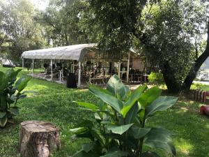 a building with a tent in a park at Tisza-beach wild camping 5 in Szeged