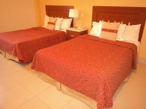 Rúm í herbergi á Hotel Fenix