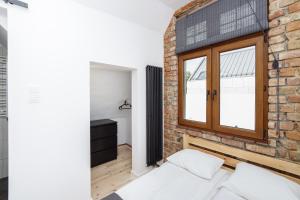 a brick wall and a window in a bedroom at Sopotel in Sopot
