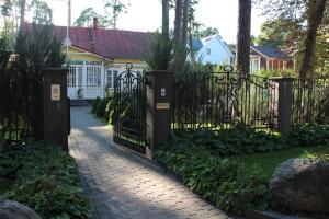 a gate in front of a house with plants at Villa Florio in Jūrmala