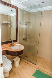 a bathroom with a sink and a shower and a toilet at Viewpark Hotel Tagaytay in Tagaytay