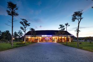 a large building with a driveway in front of it at Sao Mai Beach Resort in Tuy Hoa