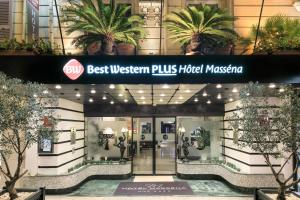 a best western plus hotel masina lobby with palm trees at Best Western Plus Hôtel Massena Nice in Nice