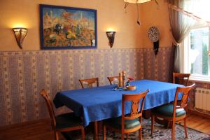 a dining room with a blue table and chairs at Villa Florio in Jūrmala +34 photos