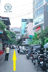 a street with motorcycles parked on the side of the road at HOSTEL TURBO in Hanoi