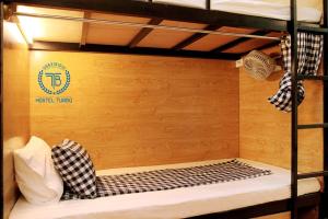 a bunk bed with a sign that says nestel hostel at HOSTEL TURBO in Hanoi