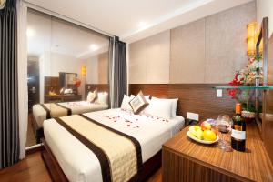 Giường trong phòng chung tại Saigonciti Hotel