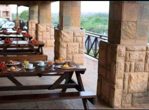 a row of tables with food on them on a balcony at Ocean View Villas A08 in Port Edward