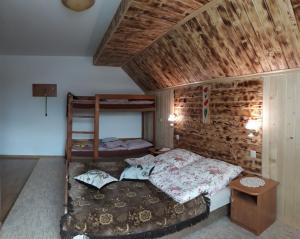 a bedroom with a bed and a wooden wall at Zielony Domek in Tylicz