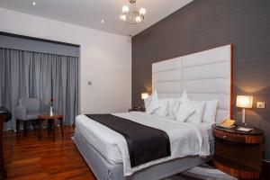 a hotel room with a large bed and a table at City Premiere Hotel Apartments - Dubai in Dubai