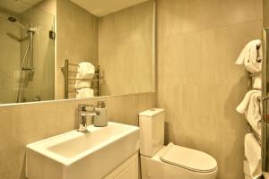a bathroom with a sink and a toilet and a mirror at Highview Central in Queenstown +23 photos