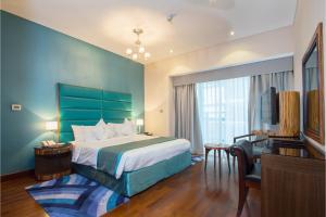 a hotel room with a bed and a desk at City Premiere Hotel Apartments - Dubai in Dubai