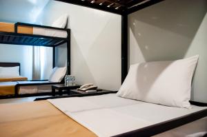 a bedroom with a bed with a mirror and a phone at Seasons Hotel Sablayan in Buenavista