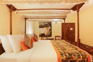 a bedroom with a bed with a canopy at The Grand Imperial - Heritage Hotel in Agra