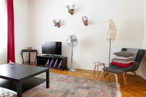 a living room with a table and a chair at Tomas's apartment in Ljubljana