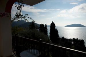 a balcony with a view of the water and mountains at Nemesis in Neo Klima