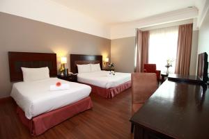 Postel nebo postele na pokoji v ubytování Grand Kampar Hotel