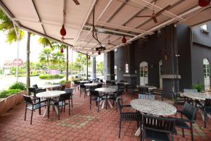 a patio with tables and chairs in a restaurant at Grand Kampar Hotel in Kampar