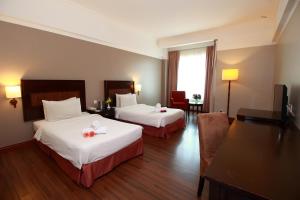 Postel nebo postele na pokoji v ubytování Grand Kampar Hotel