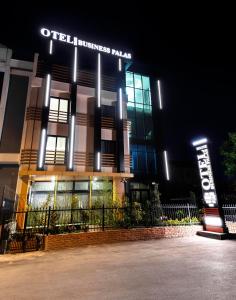 a building with a sign in front of it at night at BUSINESSPALAS DELUXE in Izmit