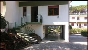 a white building with a staircase and a stair case at VILLA VERDEMARE in Paestum