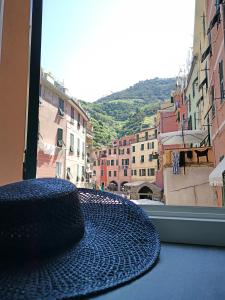 a hat sitting on a table in front of a window at Vernazza Luxury Apartment in Vernazza