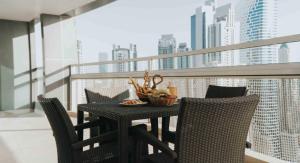 a table with chairs and a bowl of food on a balcony at City Premiere Hotel Apartments - Dubai in Dubai