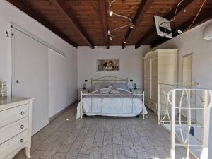 a bedroom with a bed and a wooden ceiling at Casa Chiara in Monopoli +46 photos