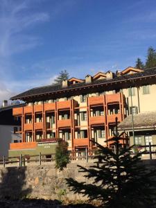 a large building with a bench in front of it at Residence Deborah in Madesimo
