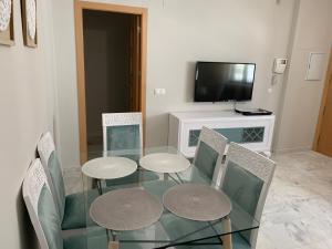 a dining room with a glass table and chairs at Apartment Lucena Center Bajo in Lucena