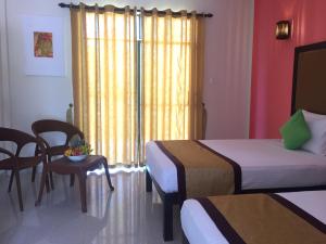 Postel nebo postele na pokoji v ubytování Organic Garden Resort Sigiriya