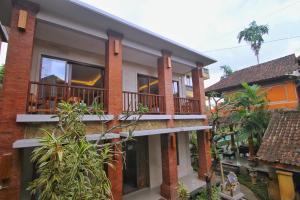 an image of a house with a balcony at The Kertha Ubud in Ubud
