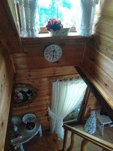 an attic room with a clock and a window at Chata Magnata in Zamość +97 photos