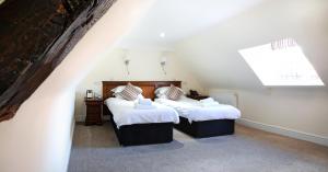 A bed or beds in a room at The Bishops Table Hotel 