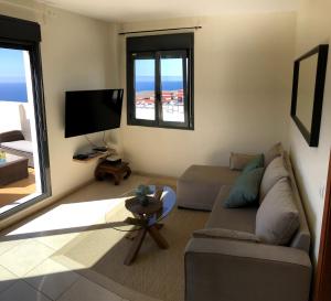 a living room with a couch and a flat screen tv at Wonderful penthouse in the center of Icod de los Vinos in Icod de los Vinos