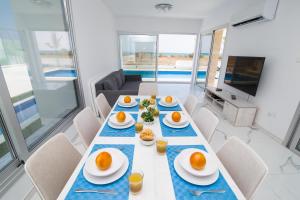 a dining room with a table with eggs on it at Villa Lynn Boutique Beachfront in Ayia Napa