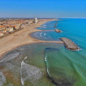 an aerial view of a beach with rocks in the water at Appartement Valras 1ere ligne vue mer in Valras-Plage