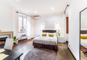 a bedroom with two beds and a fireplace at Sant'Angelo Apartments in Rome