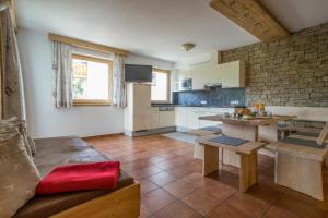 a kitchen with a couch and a table in a room at Gut Sonnbichl in Ladis