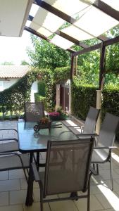 a patio with a table and chairs under a pergola at Sea Side House Kourouta in Kourouta