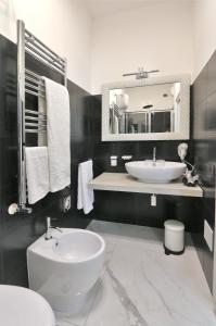 a bathroom with a sink and a toilet and a mirror at SOLIDEA BNB in Salerno +56 photos